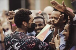 IMAGE SOURCE,GETTY IMAGES Eritrean cyclist Biniam Girmay Hailu greets fans ahead of the Giro d'Italia on Friday